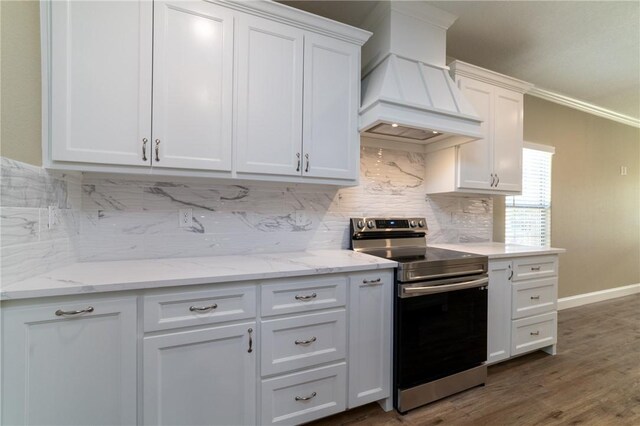 kitchen with white cabinetry, tasteful backsplash, dark hardwood / wood-style flooring, premium range hood, and electric stove