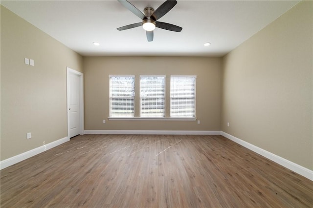 spare room with ceiling fan and hardwood / wood-style flooring