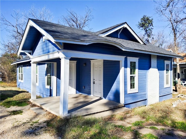 back of property with a porch