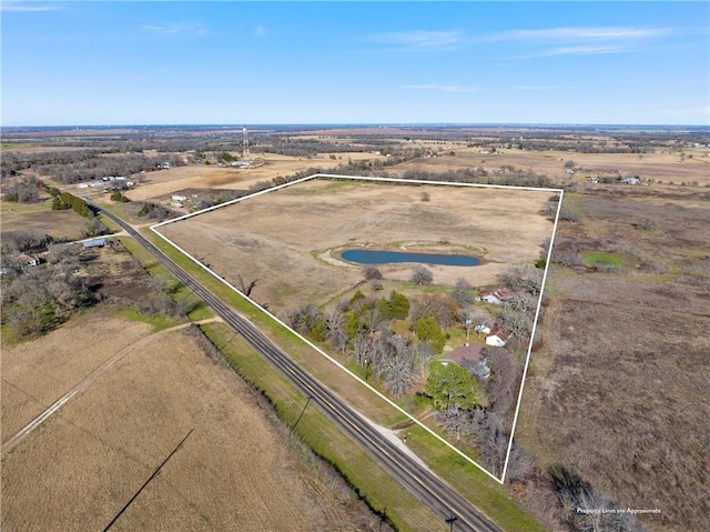 birds eye view of property with a rural view