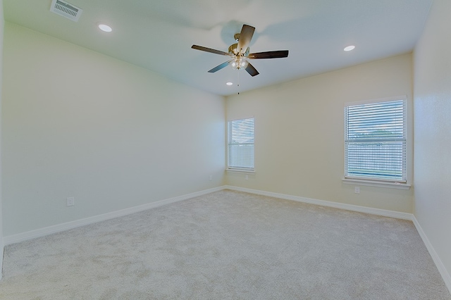 unfurnished room with light carpet and ceiling fan