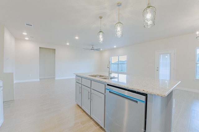 kitchen featuring a kitchen island with sink, sink, stainless steel dishwasher, ceiling fan, and decorative light fixtures