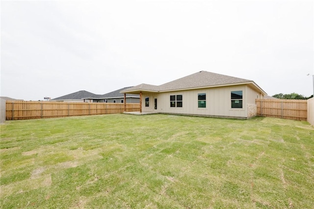 back of house with a lawn