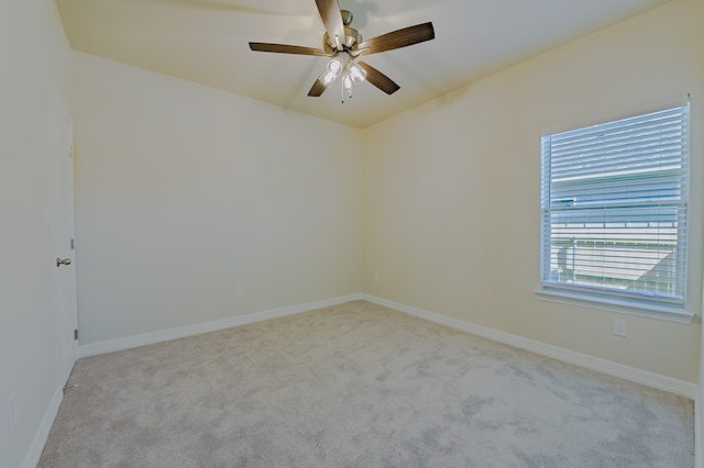 spare room featuring light carpet and ceiling fan