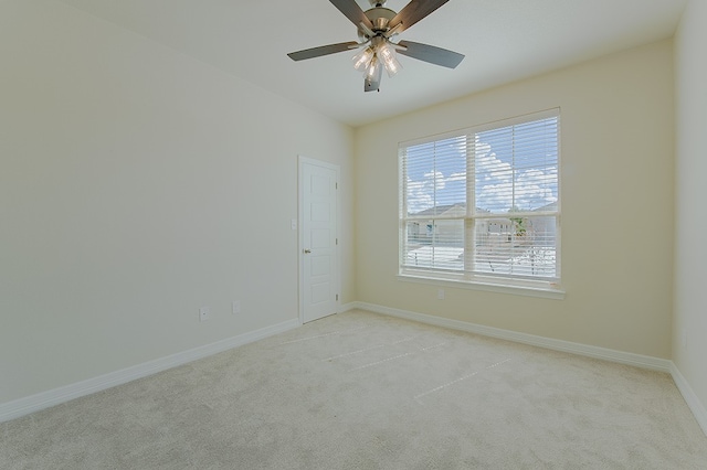 spare room with light carpet and ceiling fan