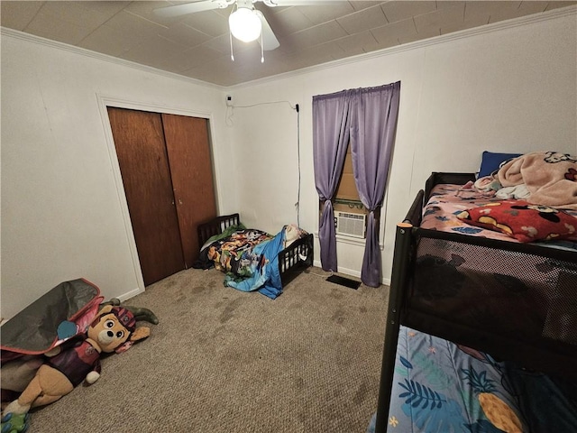 bedroom with carpet floors, ornamental molding, and a closet