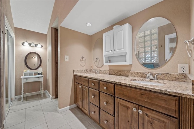 bathroom with tile patterned floors and vanity