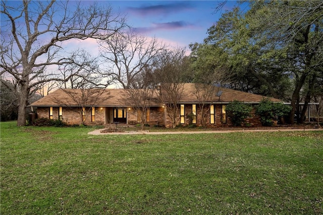 ranch-style home with a yard