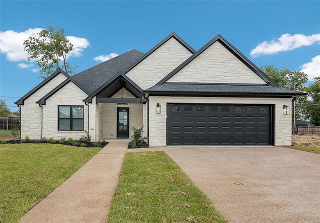 view of front facade featuring a front yard and a garage