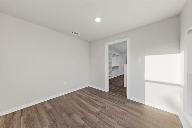 unfurnished room with dark hardwood / wood-style floors