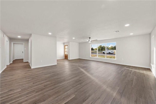 unfurnished living room with ceiling fan and dark hardwood / wood-style flooring