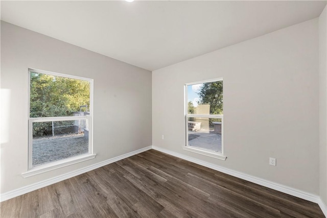 spare room featuring dark wood-type flooring