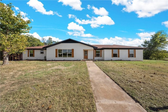 single story home with stucco siding and a front yard