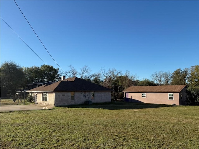 view of side of property with a yard