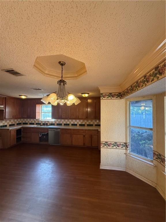 kitchen featuring hanging light fixtures, stainless steel dishwasher, a textured ceiling, a notable chandelier, and dark hardwood / wood-style flooring