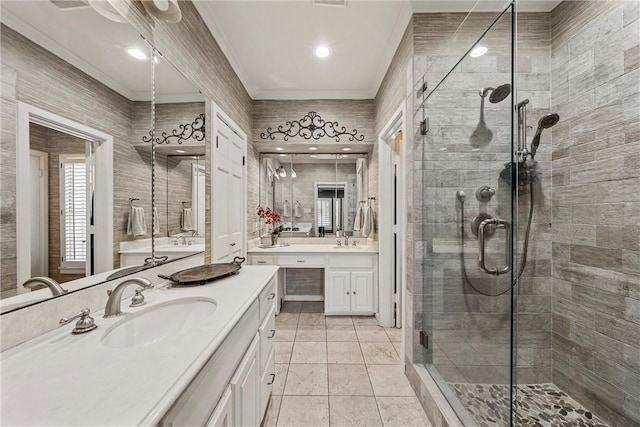 bathroom featuring ornamental molding, vanity, tile walls, and a shower with shower door