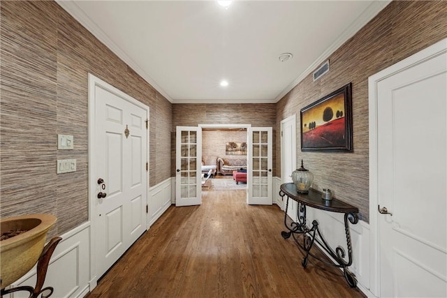 doorway featuring french doors, hardwood / wood-style flooring, and crown molding