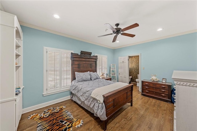 bedroom with hardwood / wood-style floors, ensuite bath, ceiling fan, and crown molding