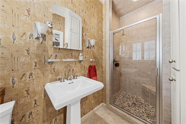 bathroom with sink, an enclosed shower, and toilet