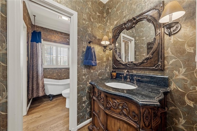 bathroom featuring hardwood / wood-style floors, vanity, ornamental molding, and toilet