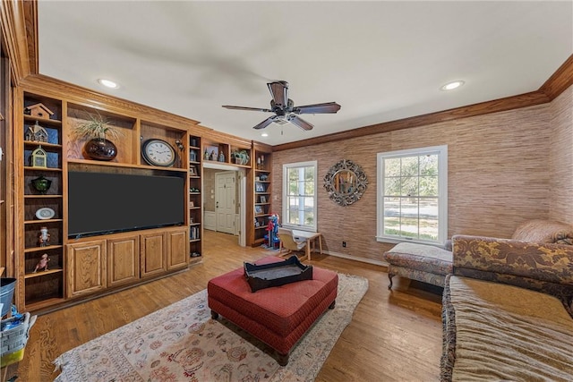 living room with ceiling fan, light hardwood / wood-style flooring, and ornamental molding