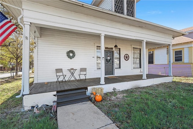 view of exterior entry with a porch