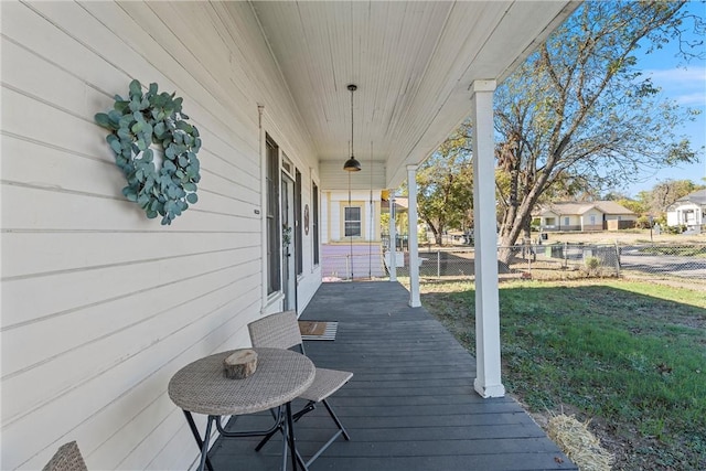 deck with covered porch and a yard