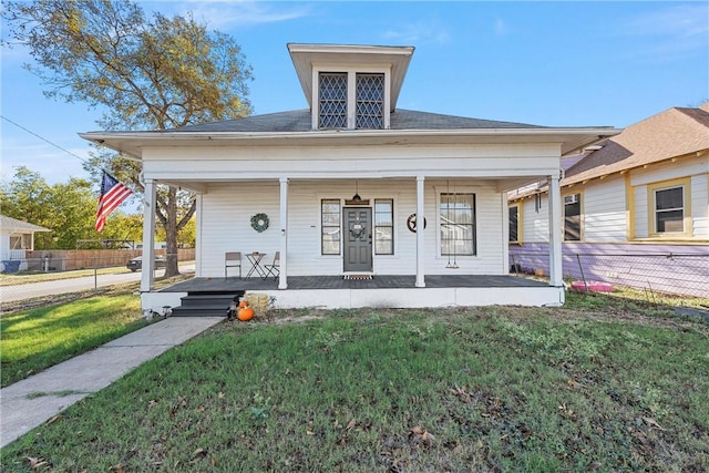 view of front of house with a front yard and a porch