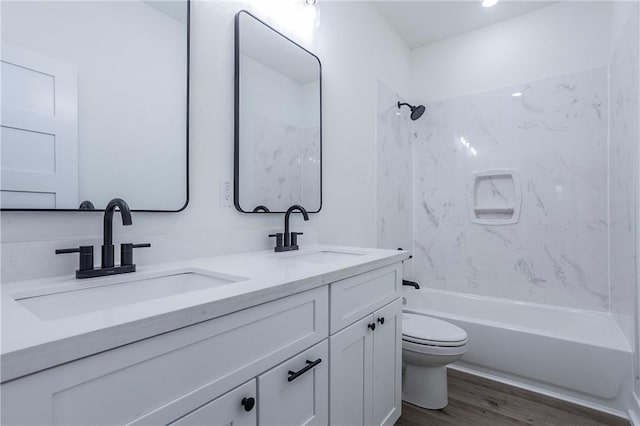 full bathroom with hardwood / wood-style flooring, vanity, toilet, and shower / bathing tub combination