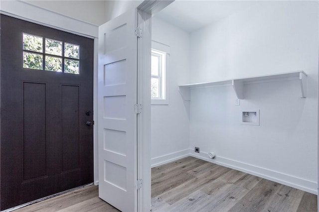 laundry area with hookup for a washing machine and light hardwood / wood-style floors