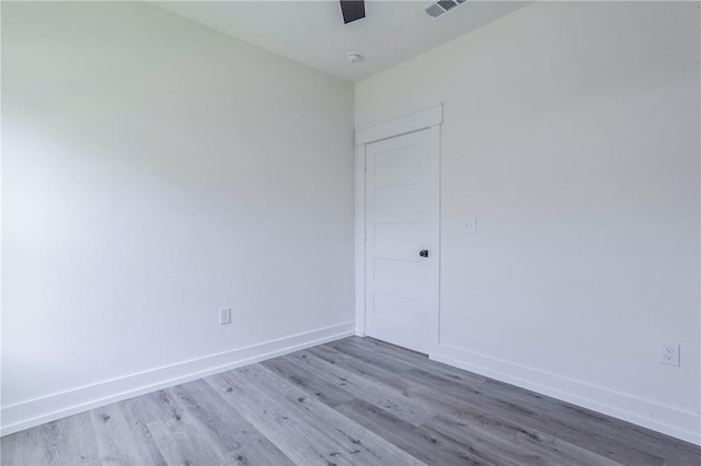 spare room with hardwood / wood-style flooring and ceiling fan