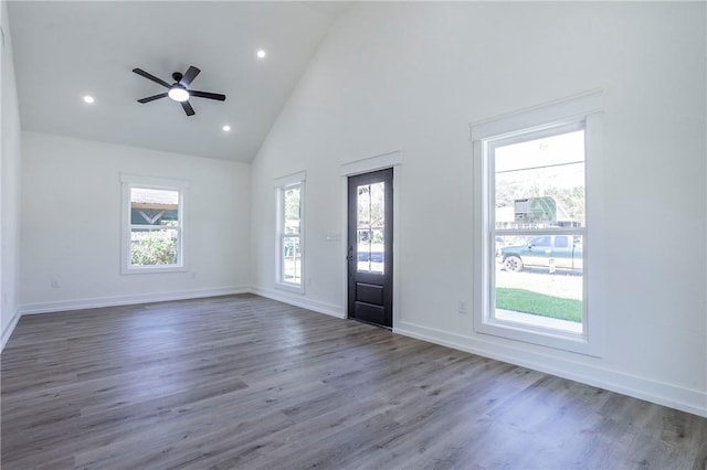 foyer entrance with ceiling fan, dark hardwood / wood-style flooring, and high vaulted ceiling