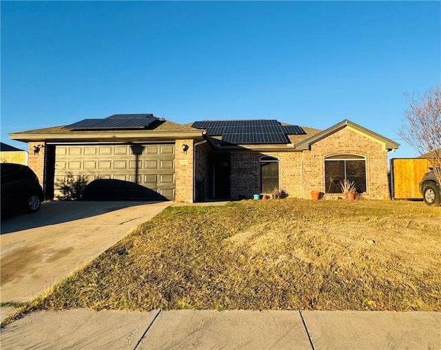 view of front of home with solar panels and a garage