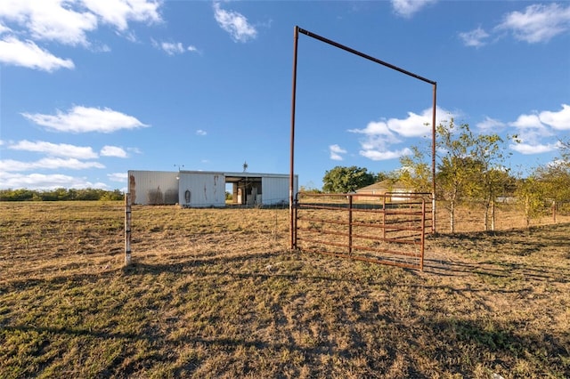 view of yard with an outbuilding and a rural view