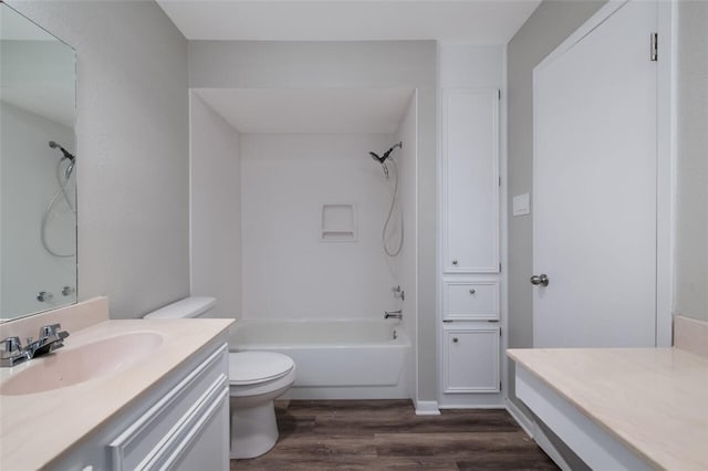 full bathroom featuring shower / bathing tub combination, hardwood / wood-style floors, vanity, and toilet