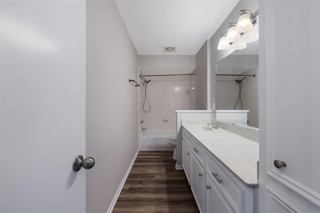 full bathroom with wood-type flooring, vanity, toilet, and tiled shower / bath