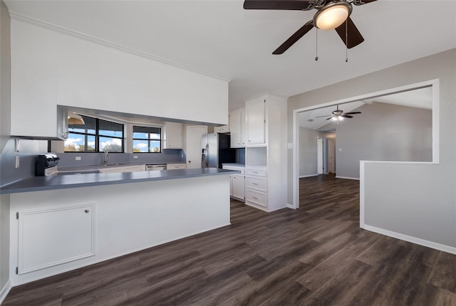 kitchen with dark wood-type flooring, range, white cabinets, stainless steel refrigerator with ice dispenser, and kitchen peninsula