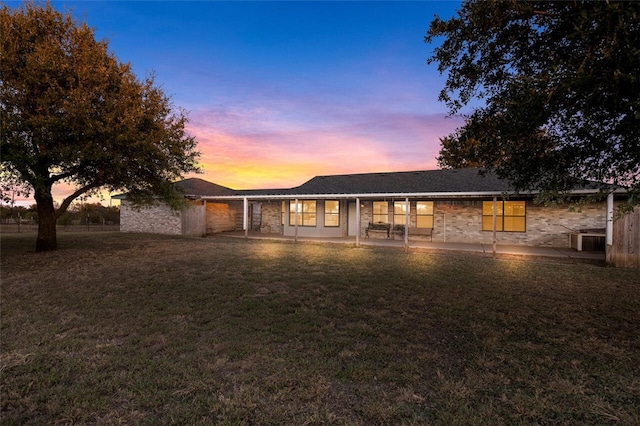 view of front of house featuring a yard and a patio