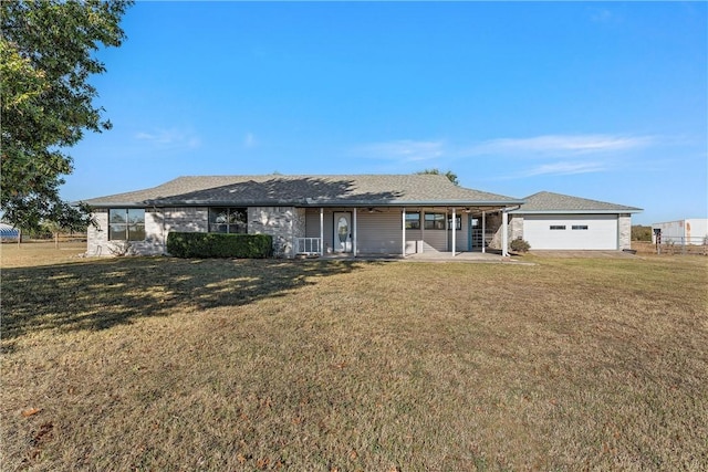 single story home with a porch, a garage, and a front yard