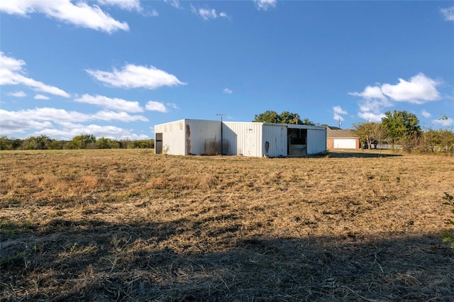 view of outdoor structure with a rural view