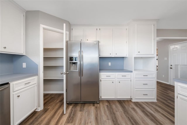 kitchen featuring dark hardwood / wood-style flooring, white cabinetry, and stainless steel appliances