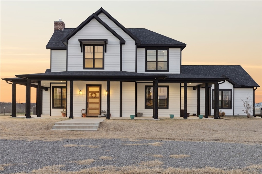 modern farmhouse with roof with shingles