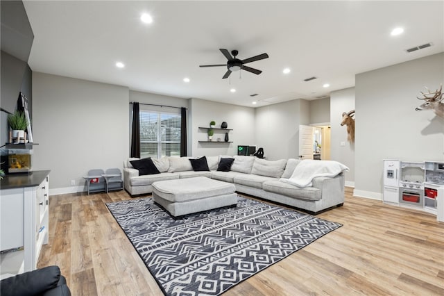 living room with baseboards, light wood-style flooring, visible vents, and recessed lighting