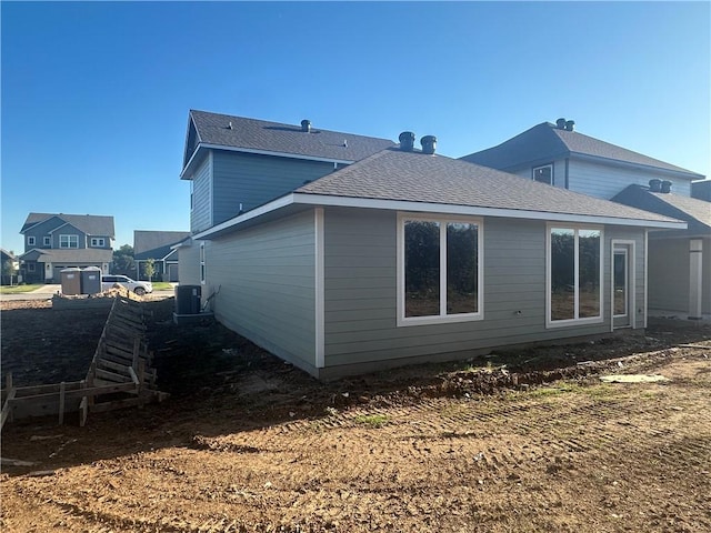 back of property featuring central AC unit