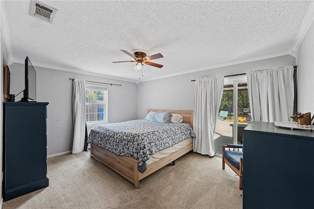 carpeted bedroom featuring access to exterior, a textured ceiling, ceiling fan, and ornamental molding