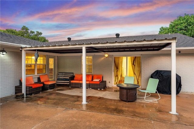 patio terrace at dusk with a grill and an outdoor hangout area