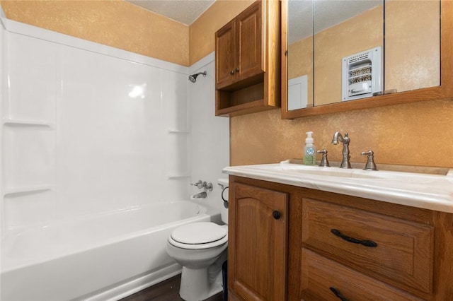 full bathroom with shower / washtub combination, vanity, wood-type flooring, and toilet