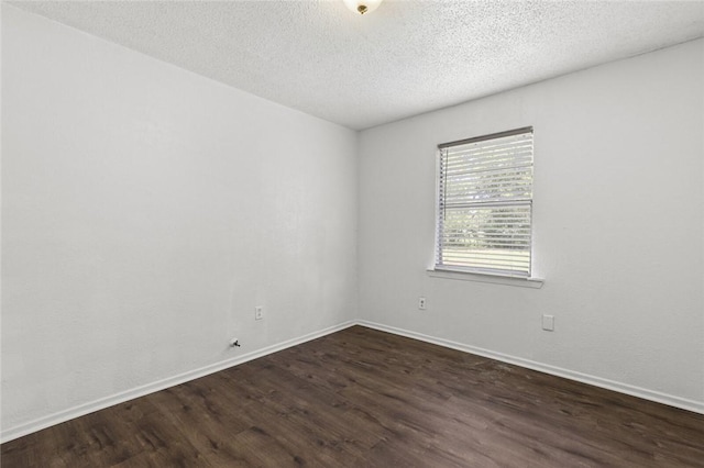 unfurnished room with dark hardwood / wood-style flooring and a textured ceiling