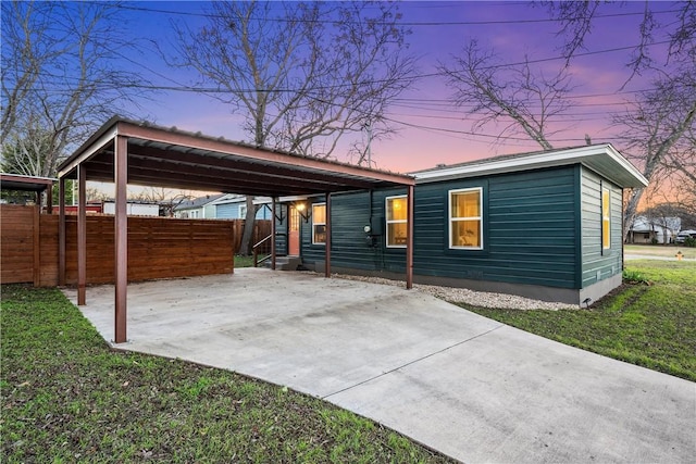 exterior space featuring a carport and a yard