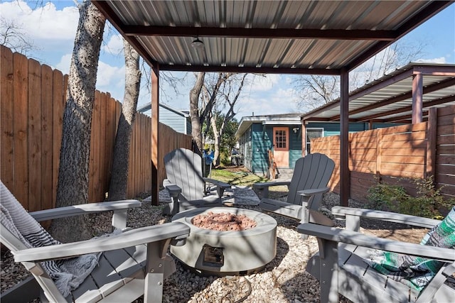 view of patio / terrace featuring an outbuilding and an outdoor fire pit